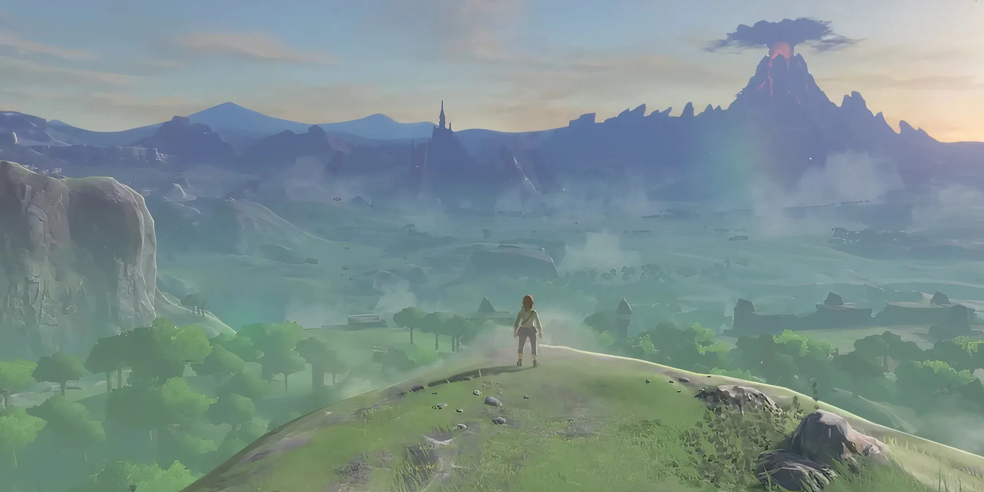 Link đứng trên vách đá nhìn ra phong cảnh Hyrule rộng lớn, mặt trời lặn trong The Legend of Zelda Breath of the Wild