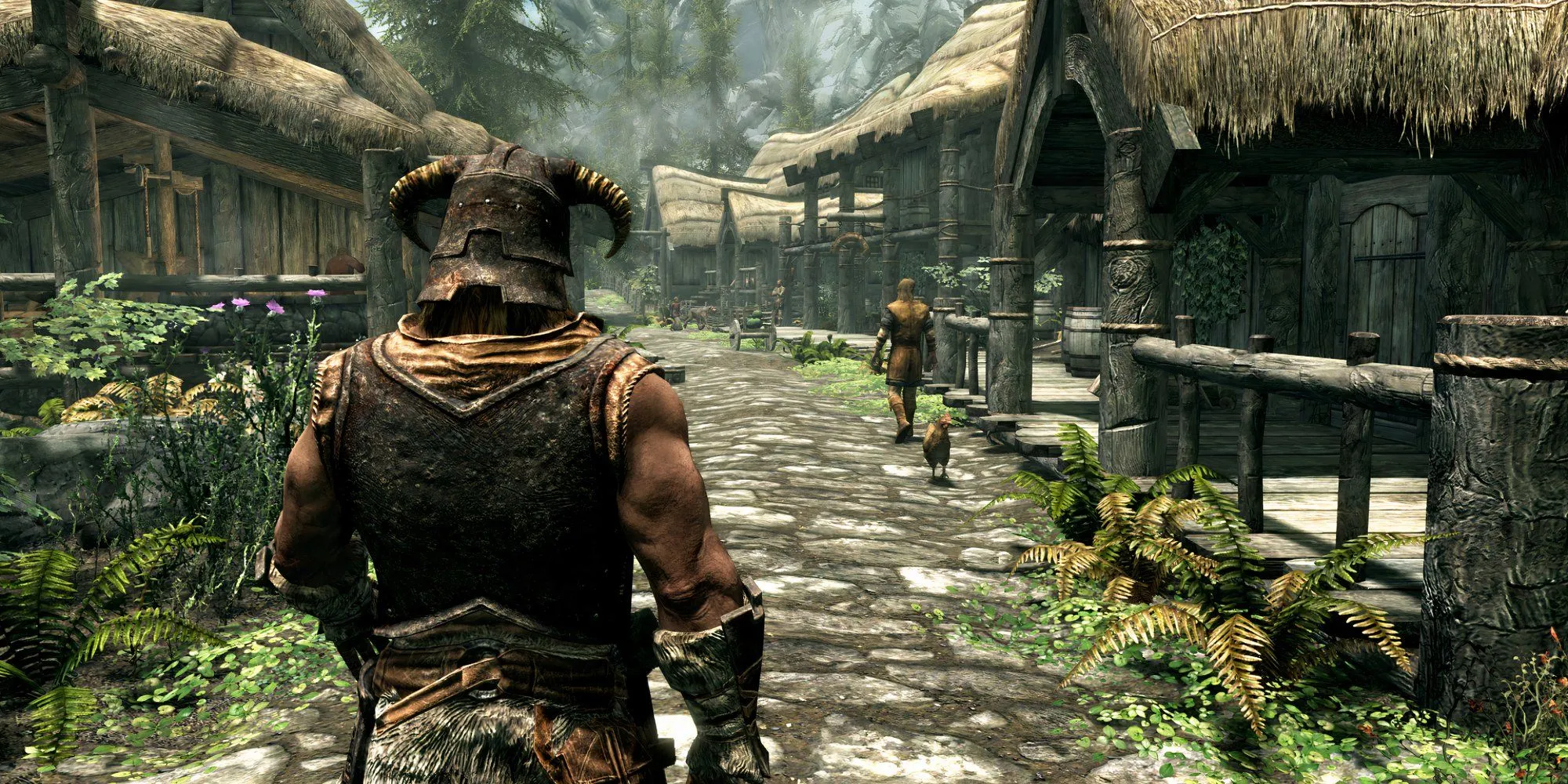Nhân vật chính trong The Elder Scrolls V Skyrim nhìn từ phía sau đứng giữa khung cảnh nhà cửa làng mạc