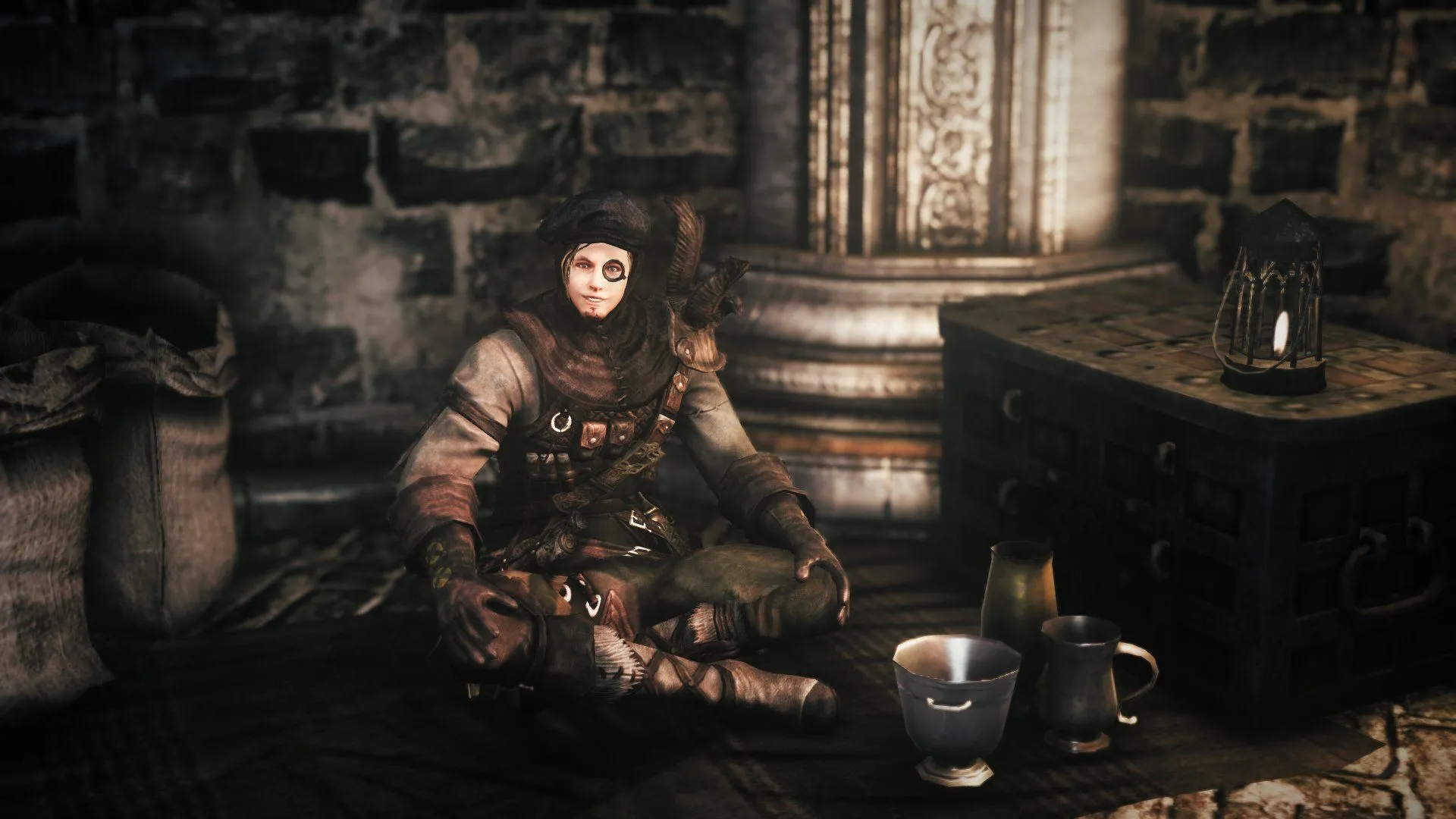 NPC Magerold ngồi bán hàng trong khu vực ngọn lửa trại ở Dark Souls 2
